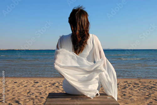 Woman sitting on beach photo