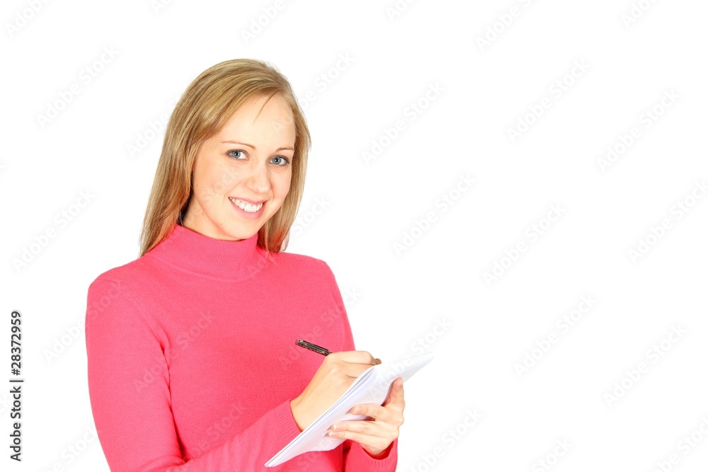 Beautiful blonde student taking notes on a paper pad with pen Beautiful blonde student taking notes on a paper pad with pen