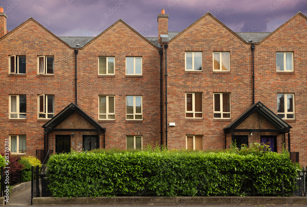 Fototapeta premium small three-story house stands beside road.