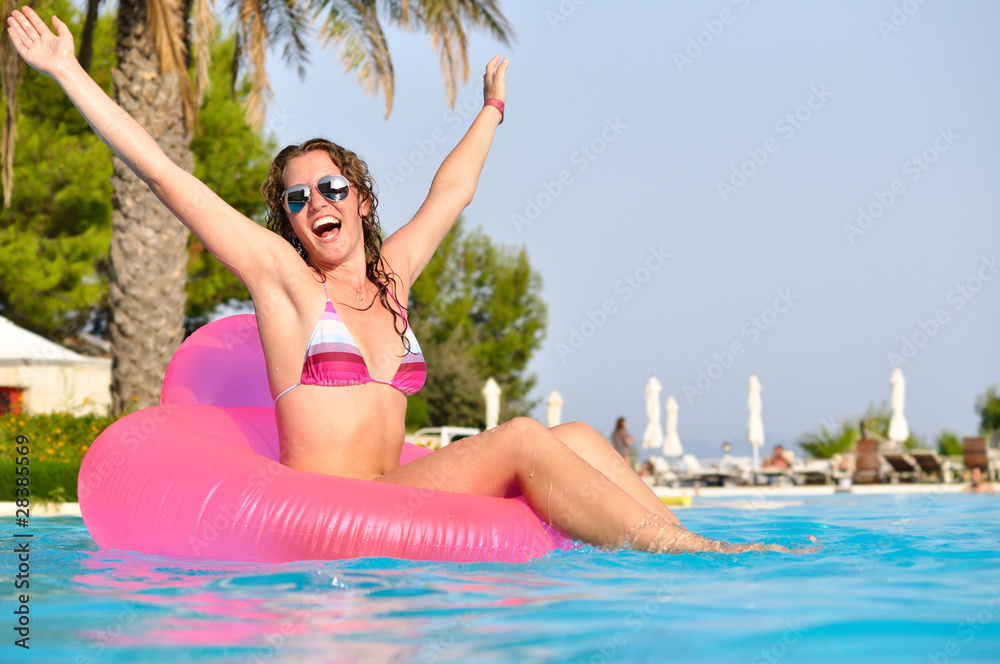 very happy woman no pink air bed in swimming pool
