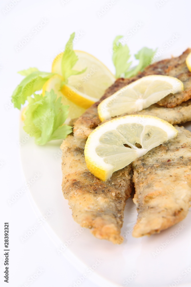 Fried fish decorated with lemon Fried fish decorated with lemon