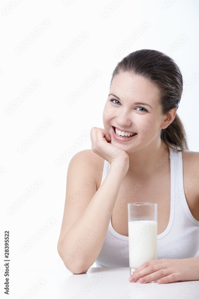 Smiling girl with a glass of milk