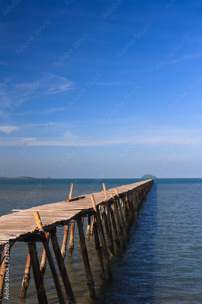 Ocean Pier stretches out from tropical island Ocean Pier stretches out from tropical island