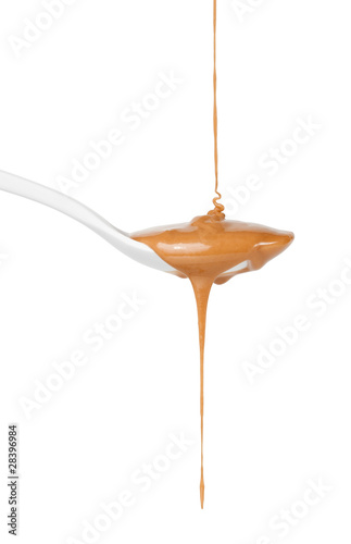 Caramel sauce dripping on spoon