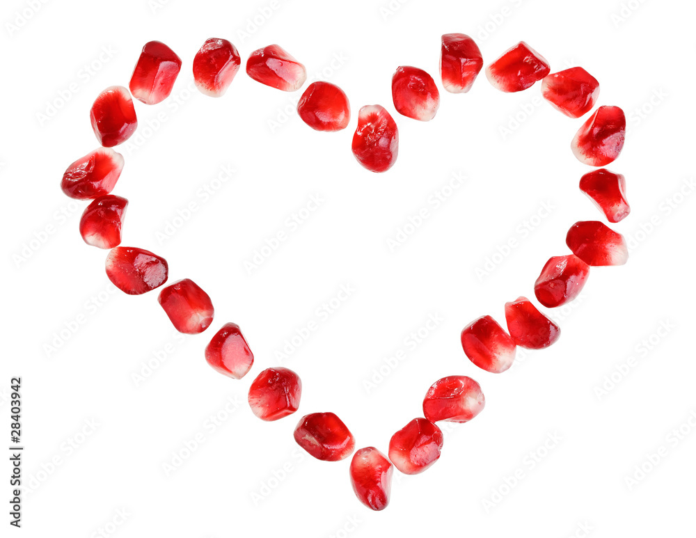 Heart symbol made from pomegranate seeds isolated on white backg