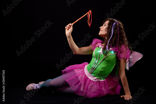 A reclined fairy plays with her magic wand