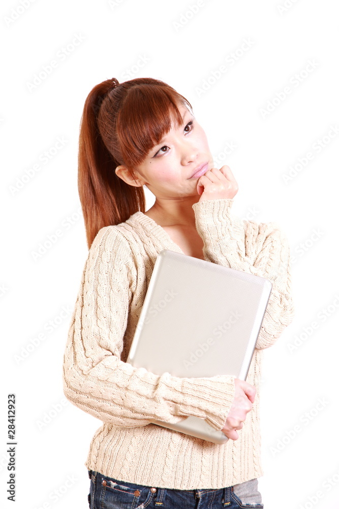 young woman with computer thinks about something young woman with computer thinks about something