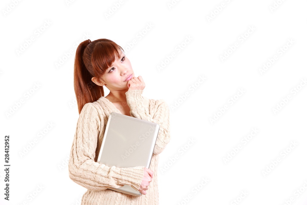 young woman with computer thinks about something young woman with computer thinks about something