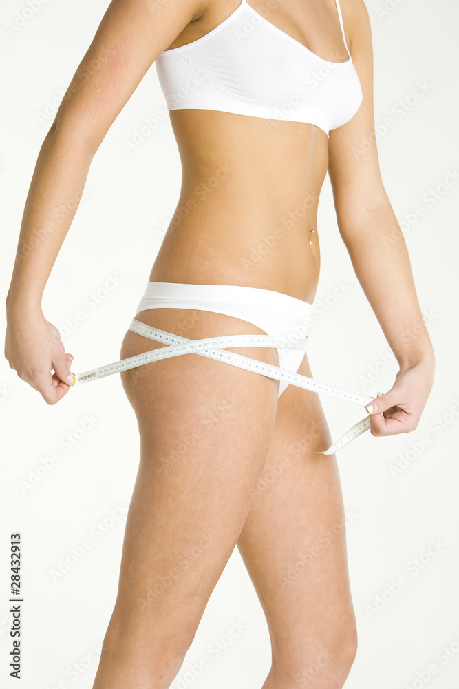 Fototapeta premium detail of woman wearing underwear with tape measure
