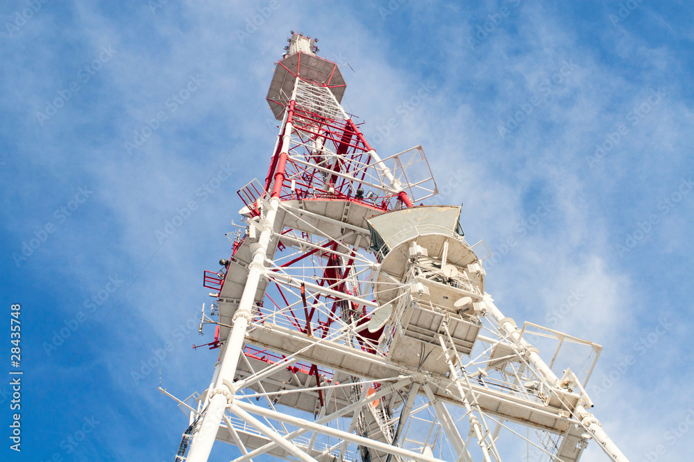 Telecommunication tower with antennas against blue sky Telecommunication tower with antennas against blue sky
