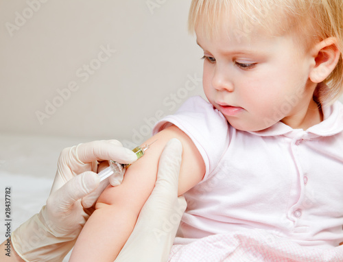 Little baby girl gets an injection photo