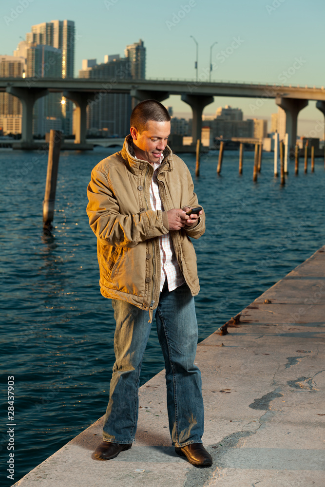 Handsome Hispanic man in a lifestyle pose with a mobile phone