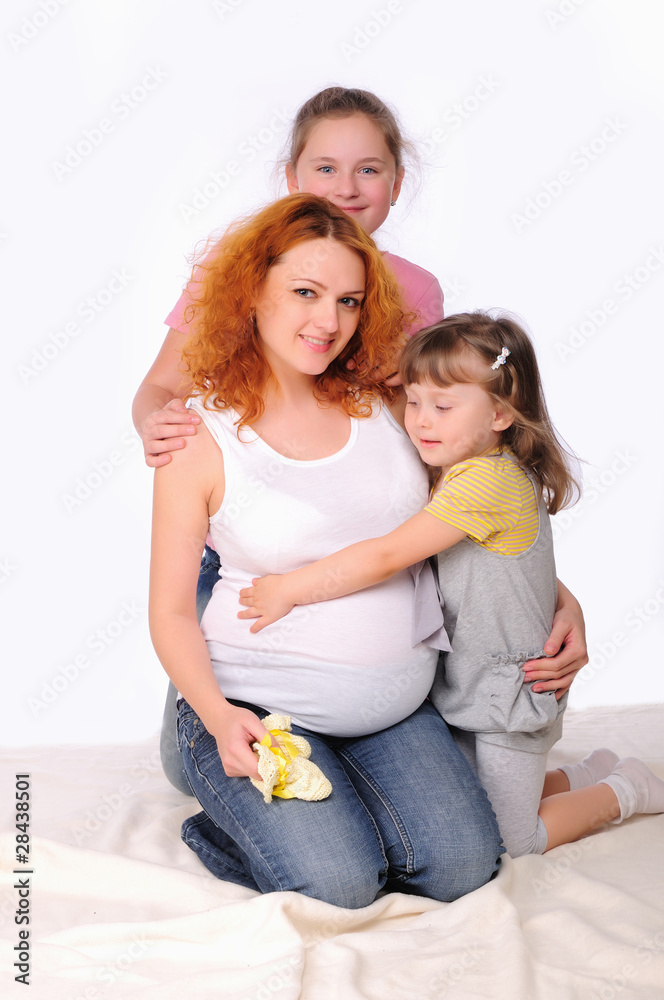 young pregnant mother and her two daughters