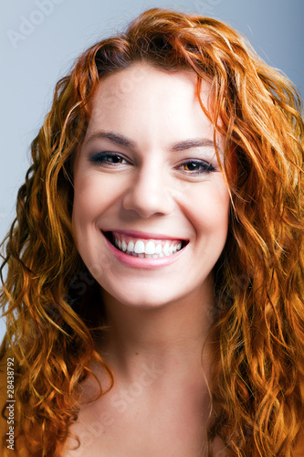 portrait of a beautiful happy young girl with red hair