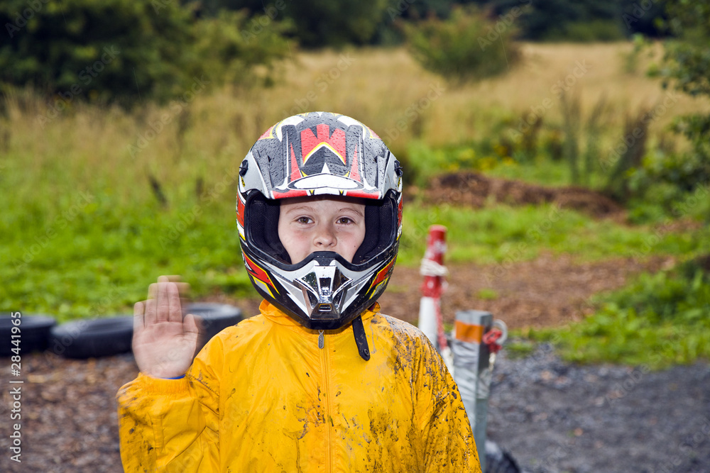 happy boy with helmet at the kart trail happy boy with helmet at the kart trail