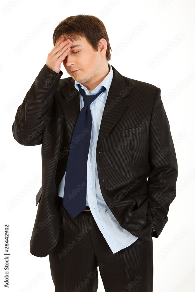 Young businessman with headache holding hand at head Young businessman with headache holding hand at head
