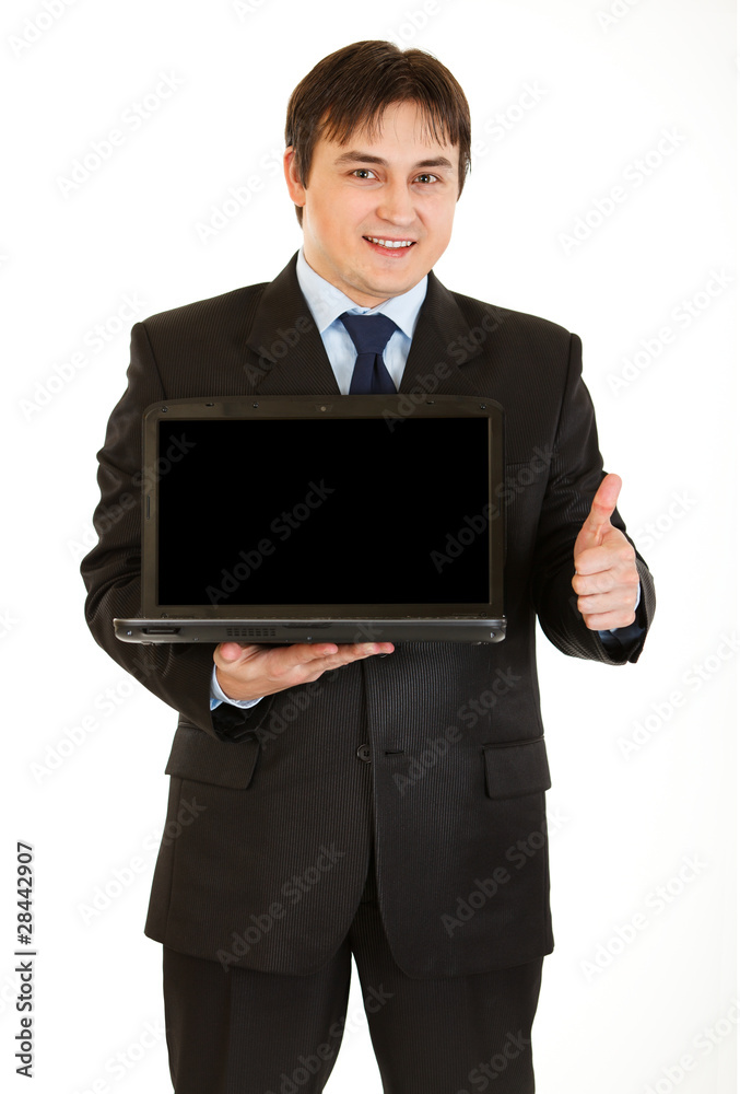 Businessman holding laptop and showing thumbs up Businessman holding laptop and showing thumbs up