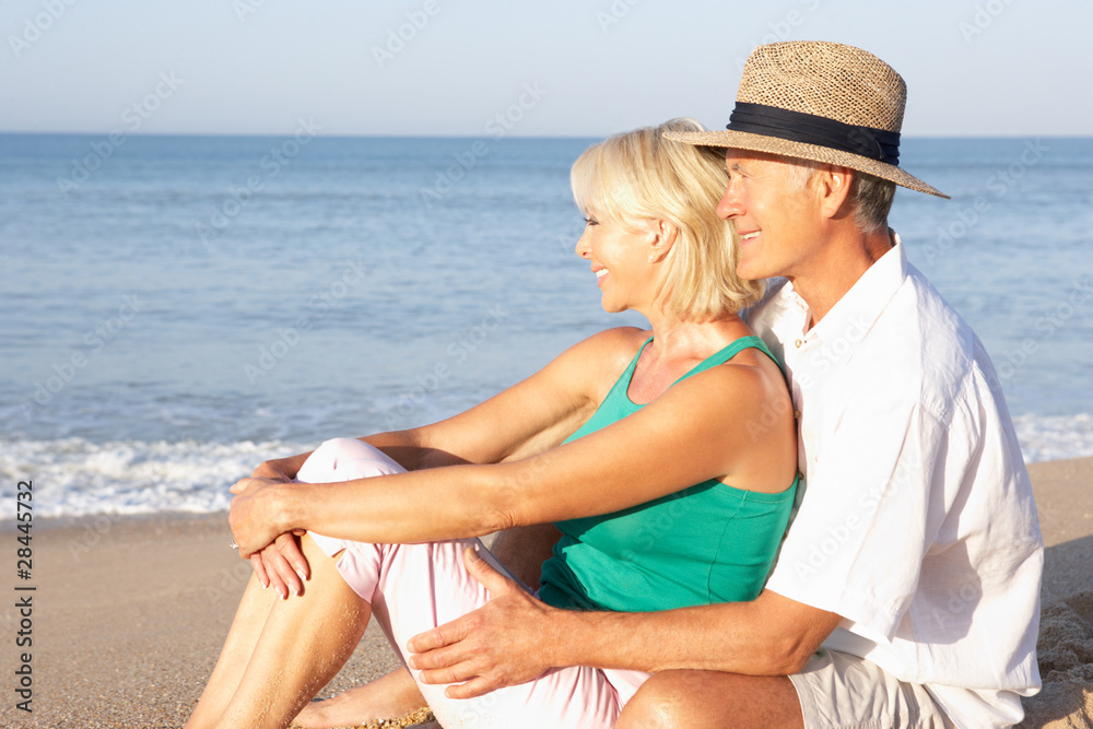 Senior couple sitting on beach relaxing Senior couple sitting on beach relaxing