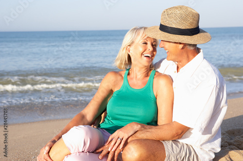 Senior couple sitting on beach relaxing