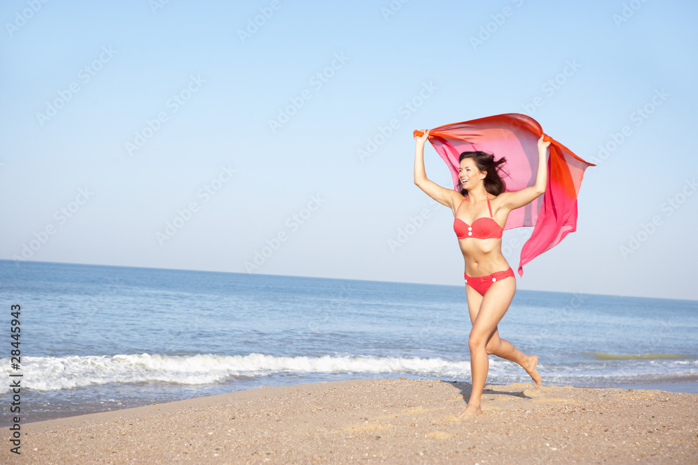 Young woman running on beach Young woman running on beach