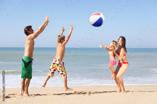 Young family play on beach