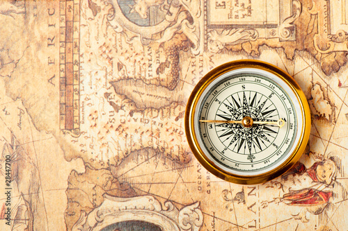 Old compass on ancient map