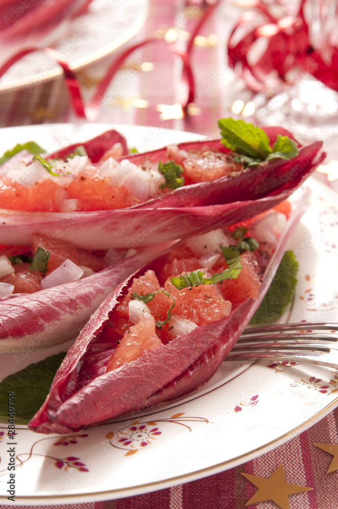 Red chicory leaves filled with pink grapefruit and onion salad g