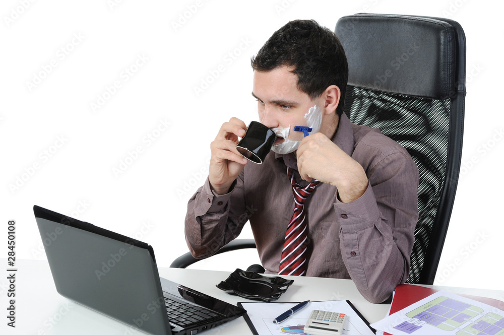 Businessman shaves in the workplace