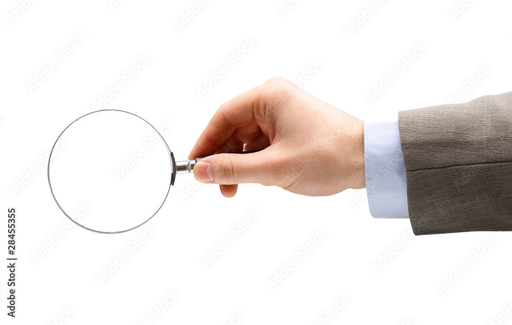 Magnifying glass in hand isolated over white
