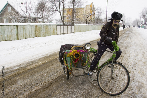 Man in mask on bicycle. photo