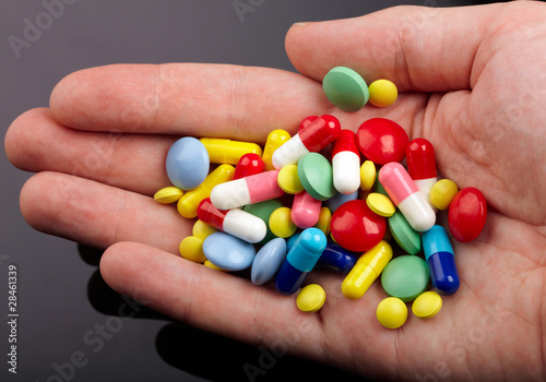 Hand with colorful pills