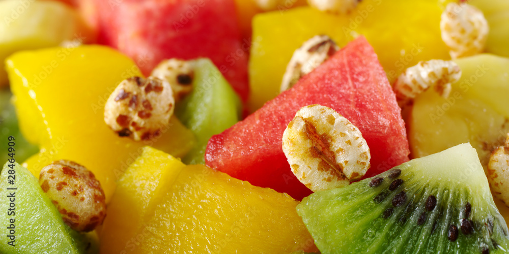 Sweetened puffed wheat cereal on fruit salad Sweetened puffed wheat cereal on fruit salad