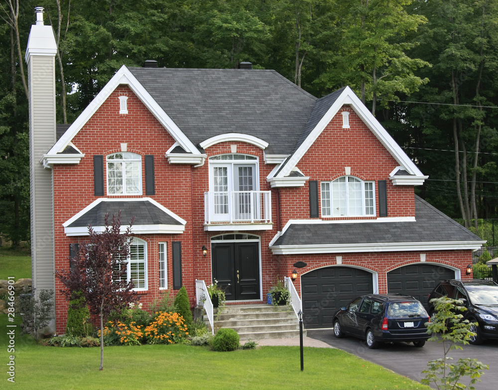 Obraz premium Modern brick home with green grass in front