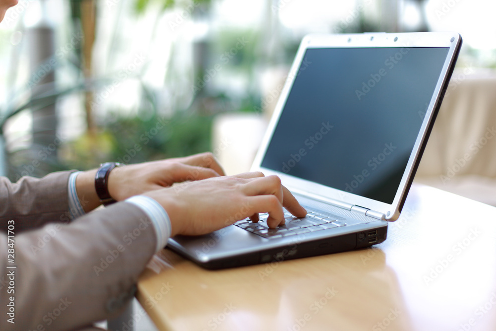 Person Typing on a modern laptop in an office Person Typing on a modern laptop in an office