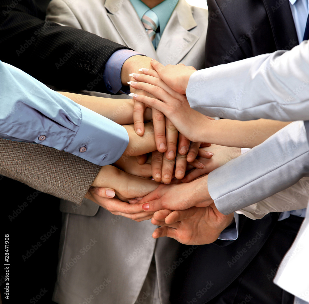 Hands piled on top of one another. Hands piled on top of one another.