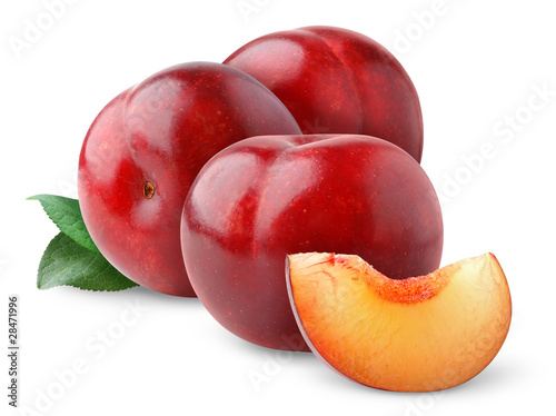 Isolated plums. Three red plums with leaves isolated on white background
