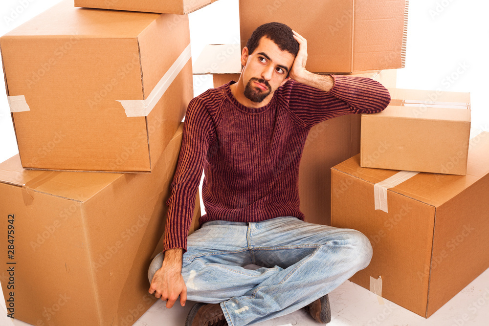 Stressed Young Man on Moving Swamped with Boxes Stressed Young Man on Moving Swamped with Boxes