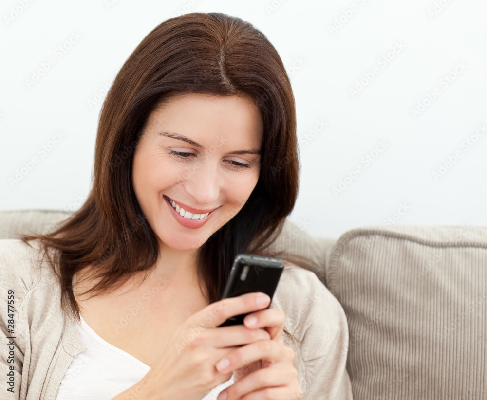 Attractive woman reading a sms on her mobile phone Attractive woman reading a sms on her mobile phone