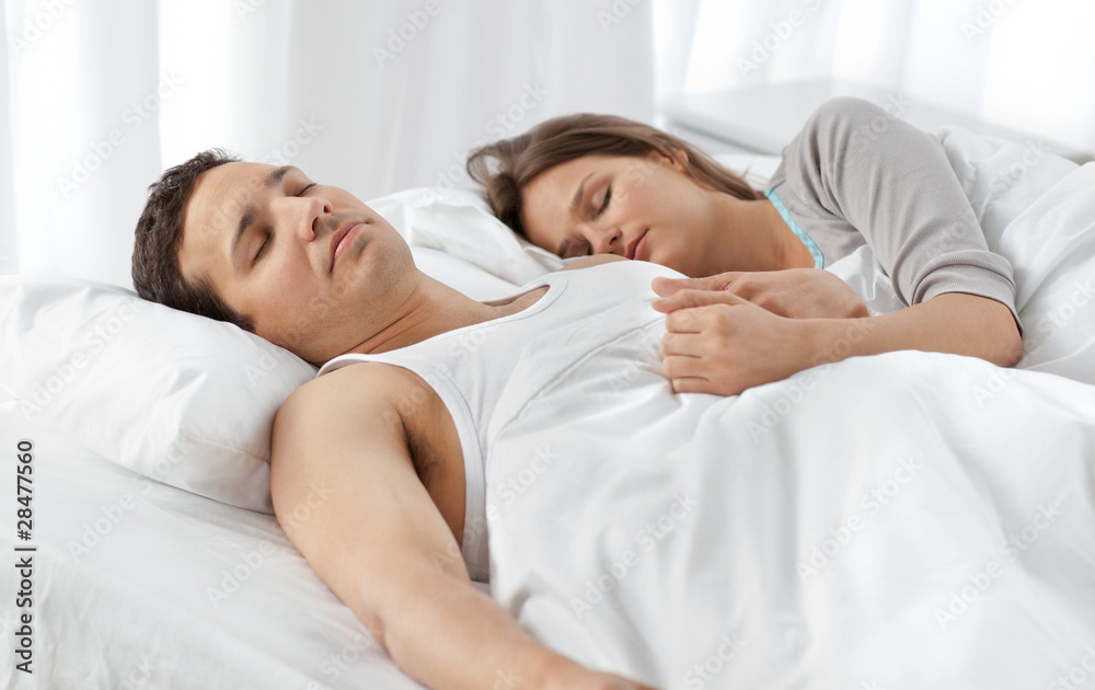 Cute couple sleeping together on their bed Cute couple sleeping together on their bed