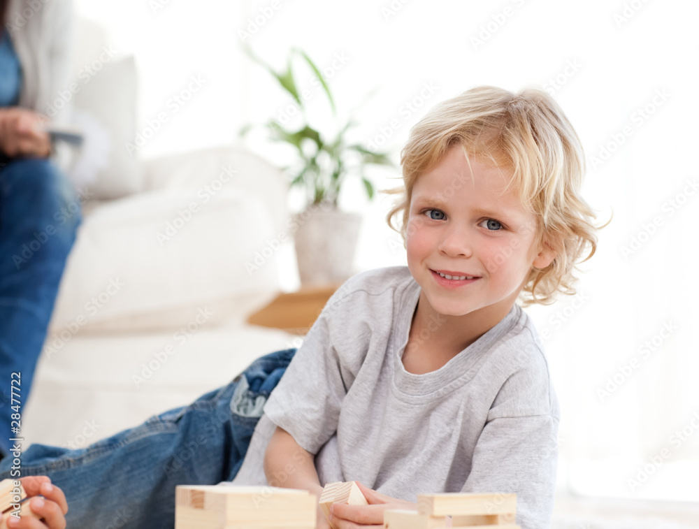 Cute child playing with dominoes in the living room Cute child playing with dominoes in the living room