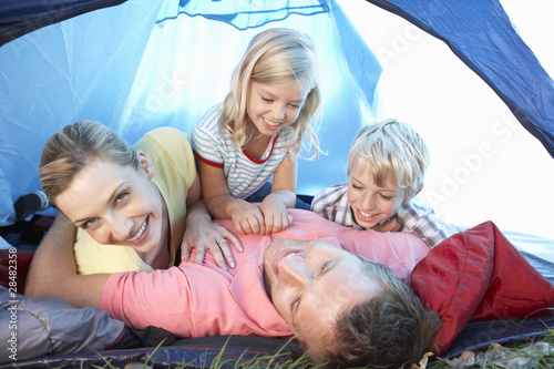 Young family playing in tent