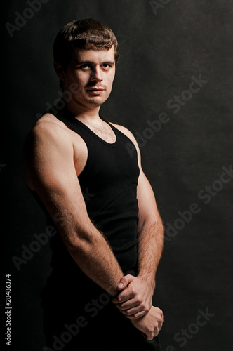 Man with an athletic body, studio portrait