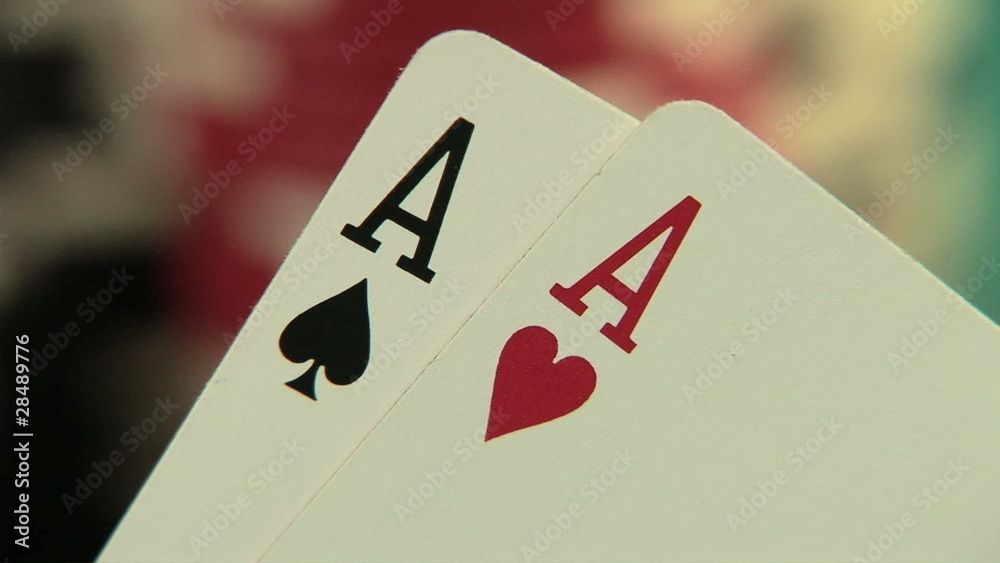 Pocket aces in a deck of playing cards with poker chips
