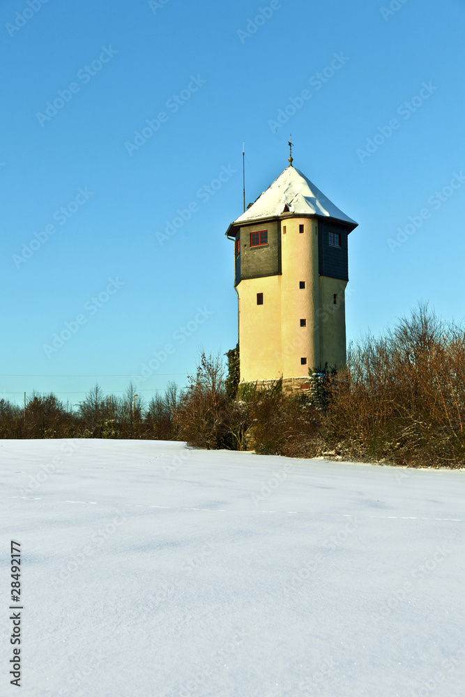 watertower in  snow covered fields