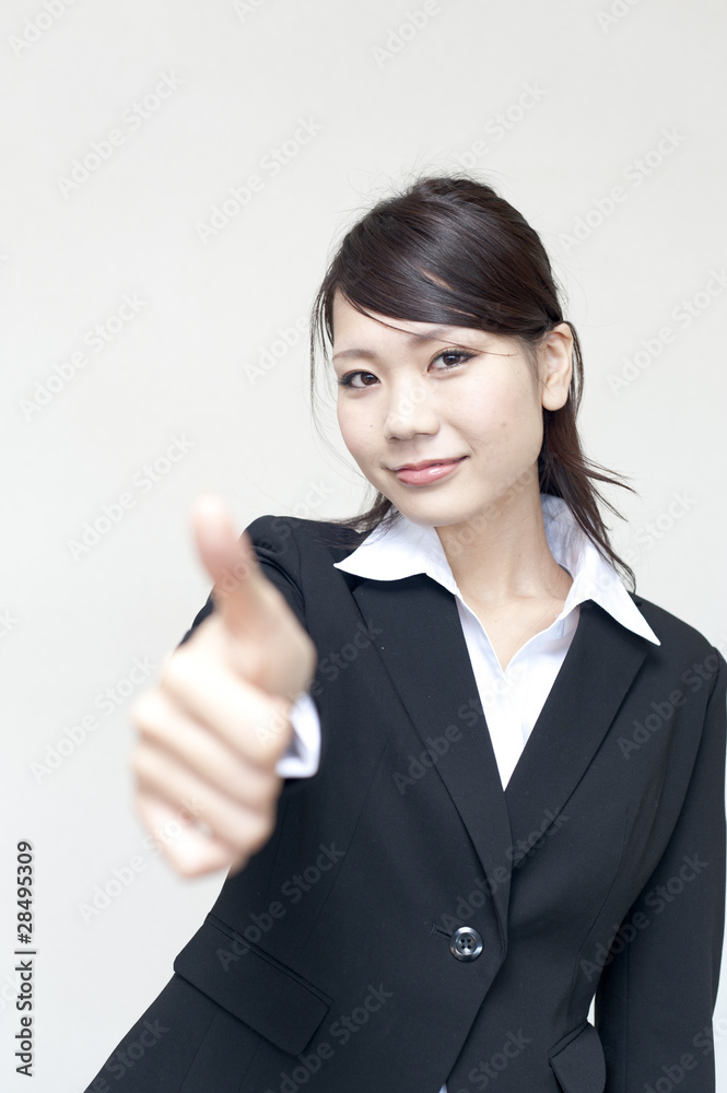 a portrait of young business woman showing thumb up a portrait of young business woman showing thumb up