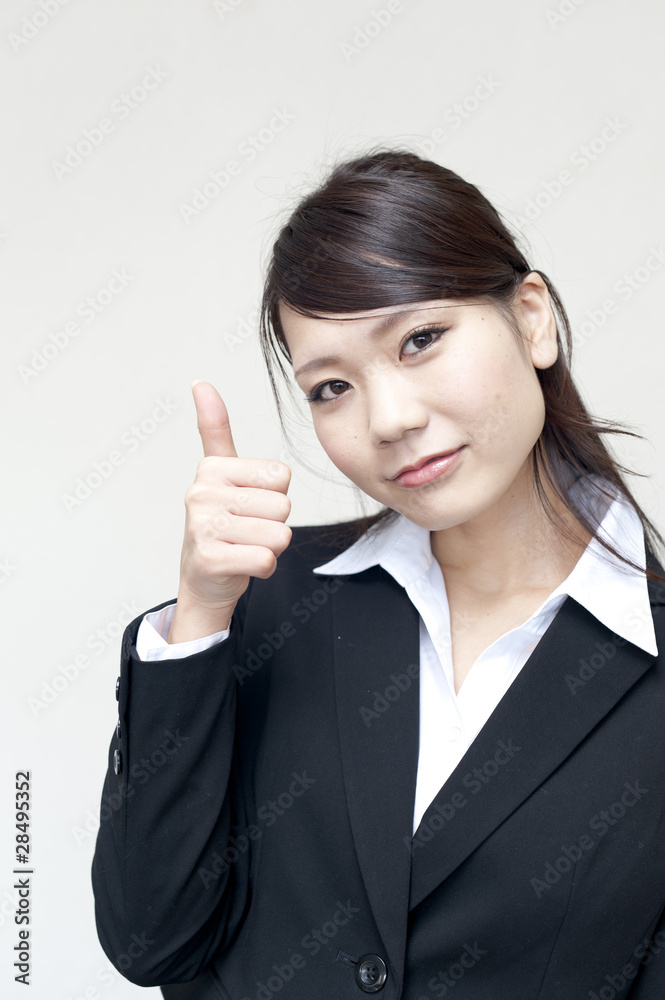 a portrait of young business woman showing thumb up a portrait of young business woman showing thumb up