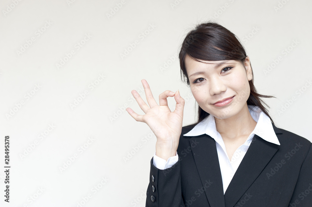 a portrait of young business woman showing okay sign