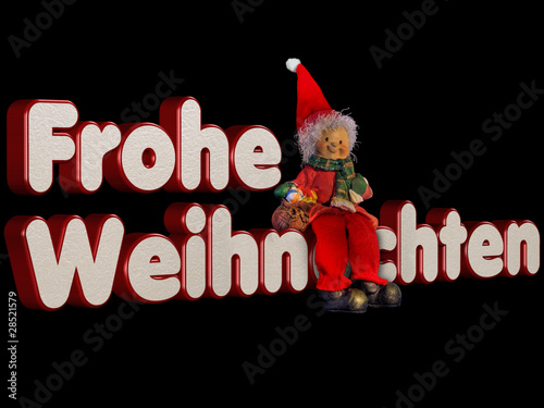 Weihnachtszwerg sitzend auf Schrift Frohe Weihnachten photo