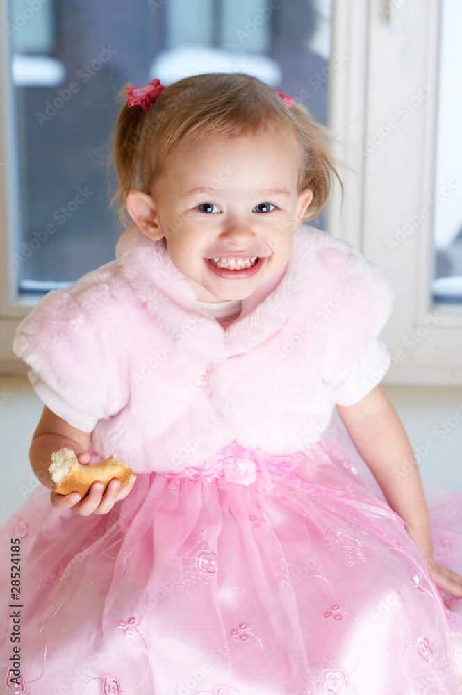 Portrait of little adorable girl. Sitting on a windowsill Portrait of little adorable girl. Sitting on a windowsill