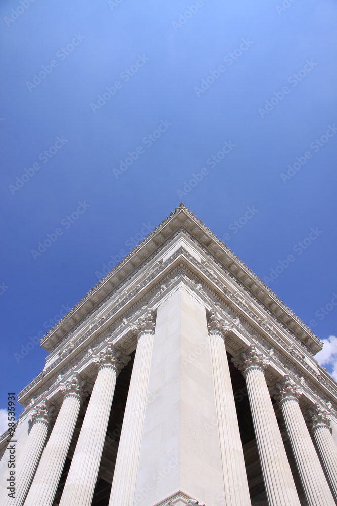 Roman Ionic Columns under a blue sky